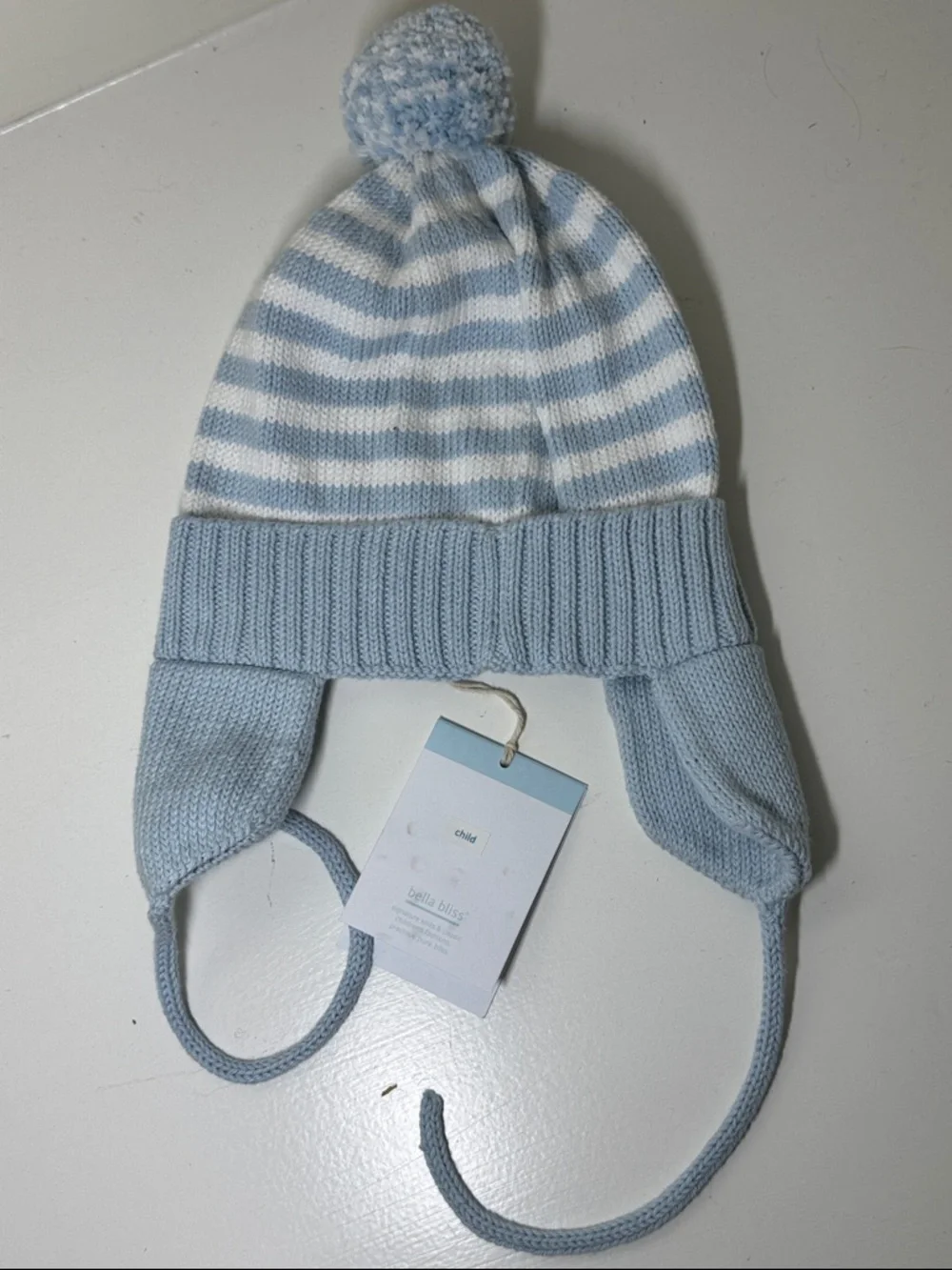 NWT Bella Bliss blue and white cotton child’s hat with ear flaps and ties.